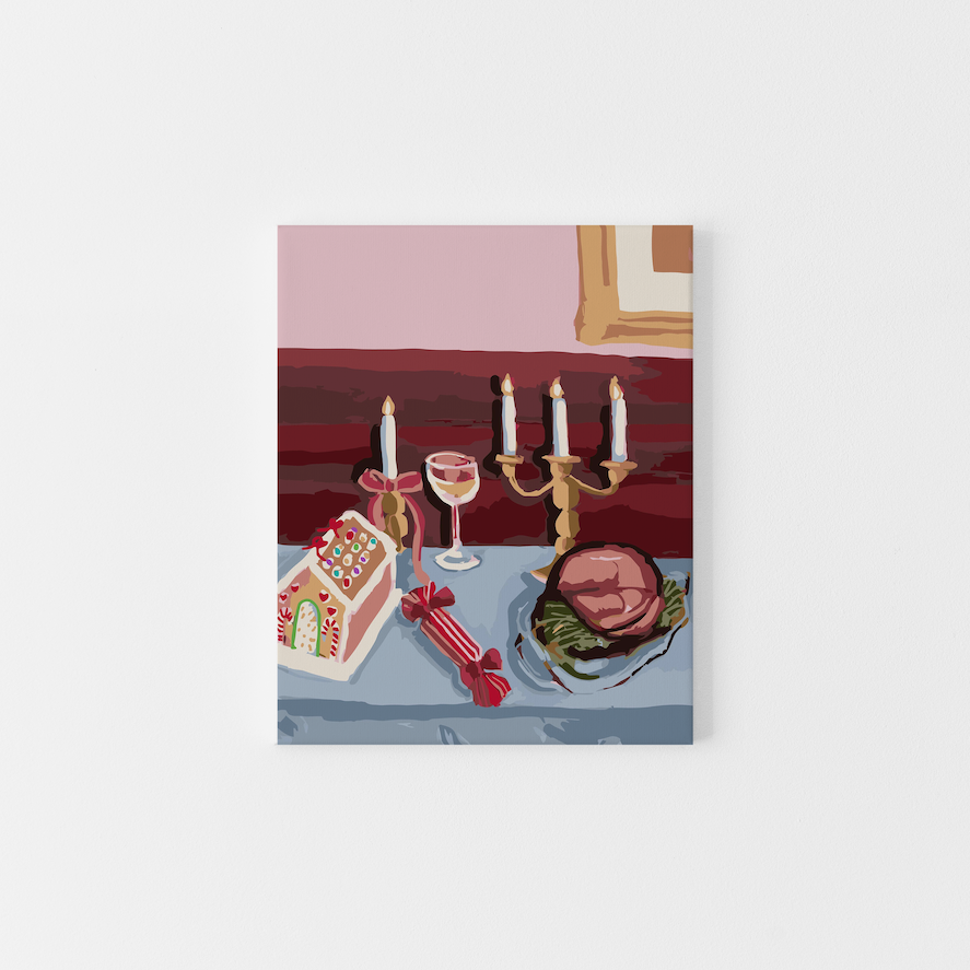 Paint Like Frida’s Christmas Dinner Big Framed Canvas — a festive paint by numbers scene featuring a holiday table set with a gingerbread house, glazed ham, bonbon, and gold candelabra, framed in a custom floating frame.