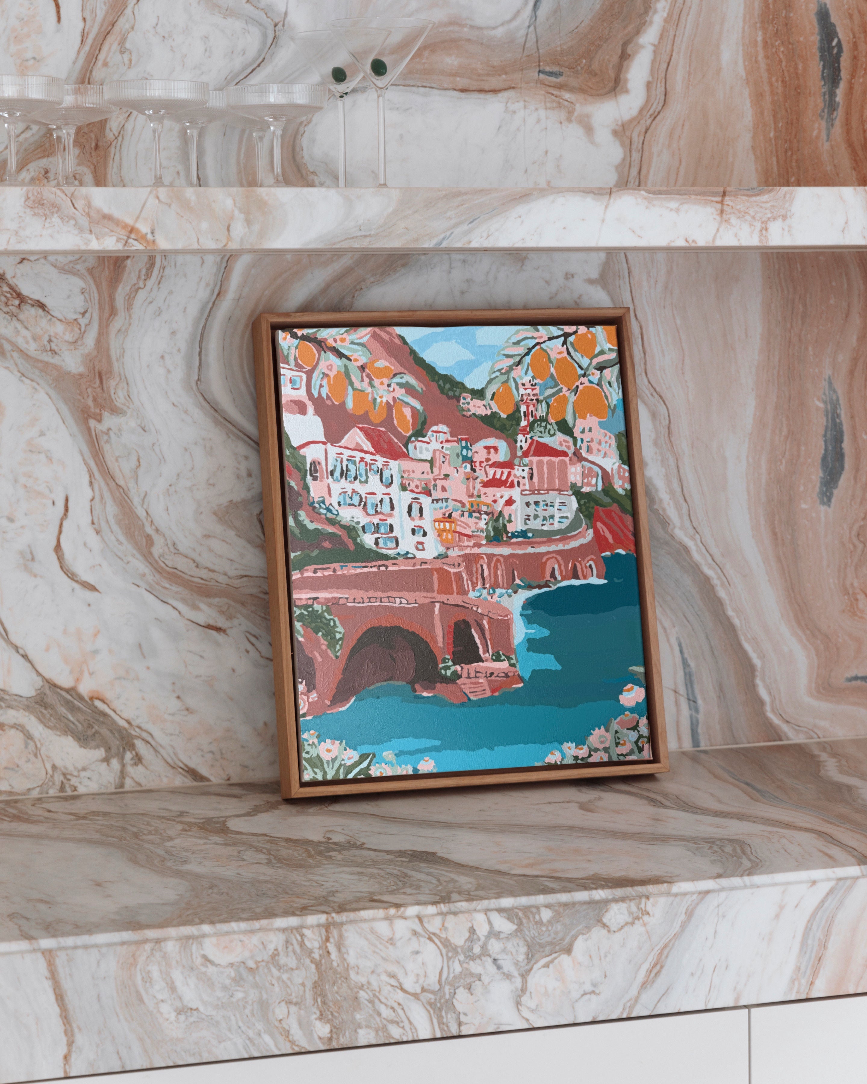 Paint Like Frida’s Where Sunshine Meets Citrus Mini Framed Canvas, styled on a marble shelf — a vibrant coastal Italian scene with lemons, rooftops, and turquoise water, pre-framed in a small custom wooden floating frame.