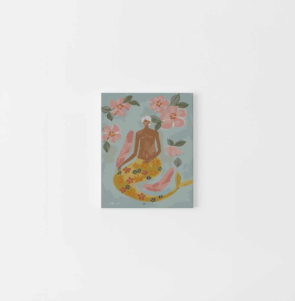 Paint Like Frida’s Lady of the Sea Mini Framed Canvas — a whimsical paint by numbers artwork of a brown-skinned mermaid with a floral tail, surrounded by soft pink flowers and feathers, pre-framed in a lightweight wooden floating frame.