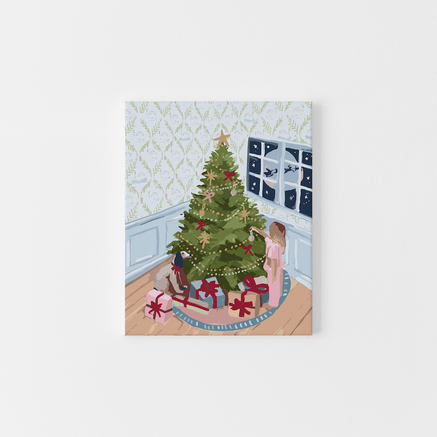 Paint Like Frida’s Christmas Eve Big Framed Canvas — a cosy paint by numbers scene of a girl decorating a Christmas tree with gingerbread ornaments and red bows, framed in a custom floating frame and ready to hang.