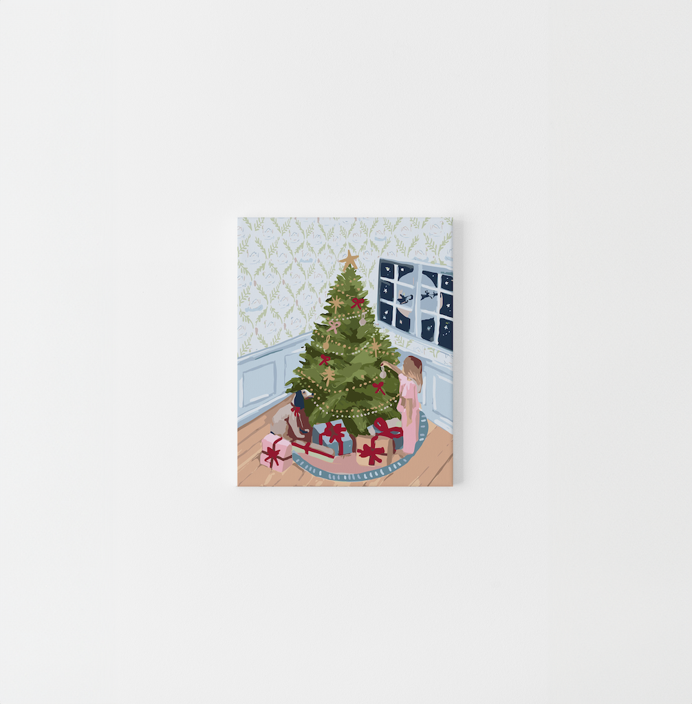 Paint Like Frida’s Christmas Eve Mini Framed Canvas — a festive paint by numbers kit featuring a girl decorating a Christmas tree surrounded by presents, in a cosy room with snowy windows, pre-stretched and ready to hang.